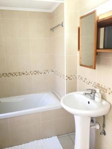 a bathroom with a sink and a bath tub at Limnaria Westpark in Paphos