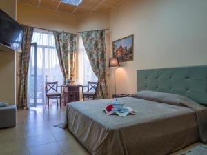 a bedroom with a bed and a table with a plate on it at Hotel Temernitskiy in Rostov on Don