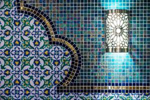 a blue tiled wall with a shower in a bathroom at Essence Hotel Boutique in Torremolinos