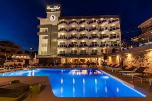 a hotel with a swimming pool in front of a building at Essence Hotel Boutique in Torremolinos