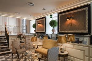 a living room filled with furniture and a fireplace at Relais & Châteaux Heritage Hotel in Madrid
