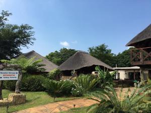 a group of huts with thatched roofs at Guinea Feather Country Lodge & Spa in Groblersdal