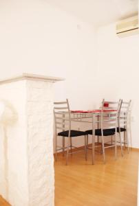 a dining room with a table and chairs at Apartments Tragurion in Trogir