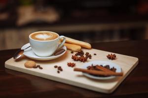 a cup of coffee sitting on a table with spices at Apartamentos Córdoba Best II in Córdoba