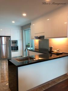 a kitchen with a black and white counter top at The Shore Walking To Jonker Streets 5 in Melaka