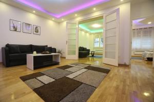 a living room with a couch and a table at De Luxe Republic Square Apartment of 100sqm in Belgrade