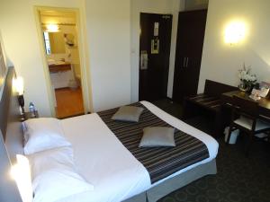 Un ou plusieurs lits dans un hébergement de l'établissement Brit Hotel Opal Centre Port