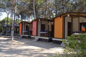 a row of colorful cabins in a row at Policoro Village Hotel in Policoro