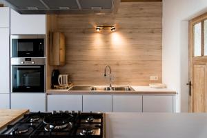 a kitchen with a sink and a stove top oven at Constantinus in Herzele
