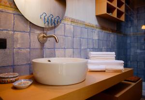 a bathroom with a sink and towels on a counter at Suite Ananda in Verbania