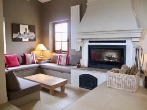 a living room with a couch and a fireplace at Le Mas du Rocher in Mérindol-les-Oliviers