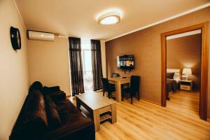 a living room with a couch and a table at Panorama Sea Tower in Batumi
