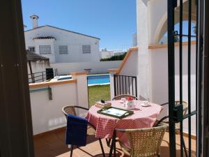 a table and chairs on the balcony of a house at Apartamentos Luna de Nerja in Nerja