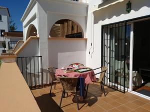 a patio with a table and chairs on a balcony at Apartamentos Luna de Nerja in Nerja