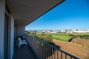 a balcony with a view of the city at Home at Azores - City View Apartment in Ponta Delgada
