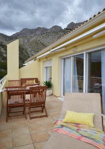 a patio with a table and chairs on a balcony at City Altea Ático 360 in Altea la Vieja