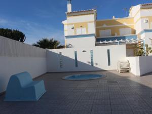 a blue chair sitting on a patio in front of a building at Europa Beach House in Manta Rota