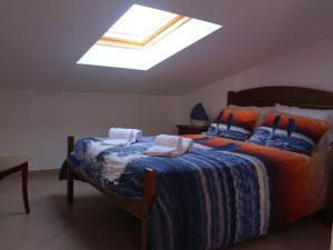 a bedroom with a large bed with a skylight at Europa Beach House in Manta Rota +39 photos