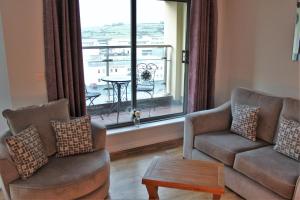 a living room with two couches and a large window at Wild Atlantic Accommodation 18 Glenveagh Court in Letterkenny