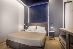 A bed or beds in a room at Blu Notte Guest House
