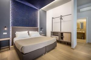 A bed or beds in a room at Blu Notte Guest House
