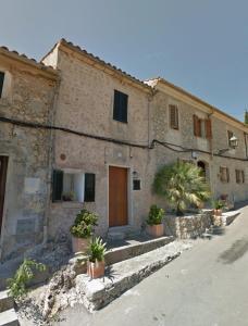 a stone building with potted plants in front of it at Gruat 31 - Vallem Properties in Pollença