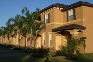 a house with palm trees in front of it at Regal Palms Resort & Spa in Davenport