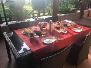 a red table with food on top of it at B&B Mongiardino in La Maddalena