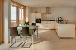 a kitchen with a table and chairs in a kitchen at Apartment Meric Superior in Zermatt