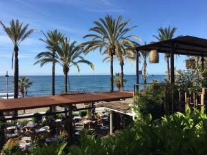 a view of the ocean from a resort with palm trees at Las Palmas in Marbella
