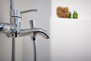 a bathroom sink with a chrome faucet at Blanco Rooms Mykonos in Mikonos