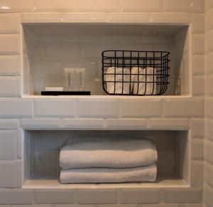 a towel shelf in a bathroom with towels at Hôtel Le Mistral in Marseille