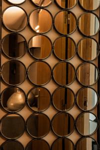 a wall of mirrors on a wall at Hôtel Le Mistral in Marseille
