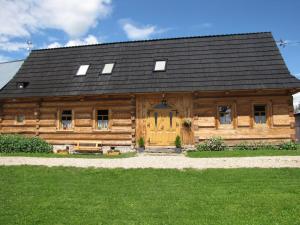 a large wooden house with a black roof at BoBak noclegi in Chochołów