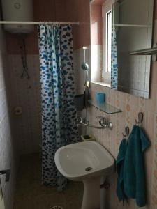 a bathroom with a sink and a shower curtain at Poborska Villa in Ulcinj +59 photos