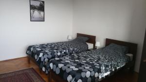a bedroom with two beds and a picture on the wall at Poborska Villa in Ulcinj