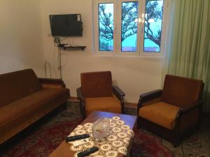 a living room with a couch and two chairs and a table at Poborska Villa in Ulcinj