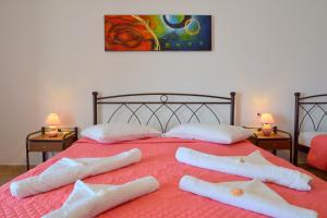 1 cama con 2 almohadas y toallas en Aperanto galazio, en Agia Kiriaki Beach