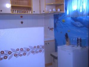 a kitchen with a white refrigerator and a blue wall at Marysol Lodging in San Andrés +24 photos