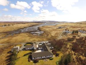 an aerial view of a house on a hill next to a river at Hame on Skye in Lonmore