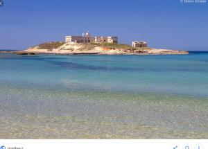 a house on top of an island in the water at Casa Vacanze Il Quadrifoglio in Noto