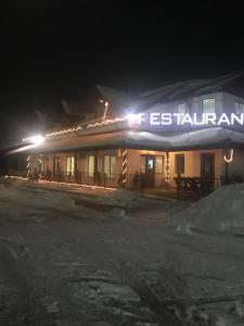 a hotel at night with a sign that reads festival at KM 80 Restaurant & Hotel in Mavrodolu