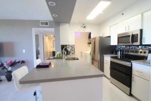 a large kitchen with a counter top and appliances at Yacht Club at Aventura 1 Bd 1 Bth Brand New in Aventura