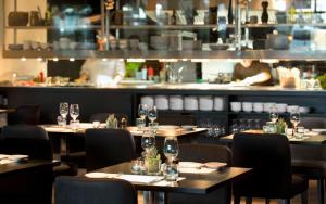a restaurant with tables and chairs with glasses on them at Wyndham Stuttgart Airport Messe in Stuttgart