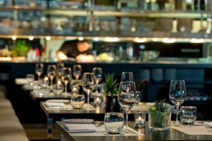 a row of wine glasses on a table in a restaurant at Wyndham Stuttgart Airport Messe in Stuttgart