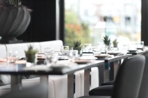 a table with glasses and plates on top at Wyndham Stuttgart Airport Messe in Stuttgart