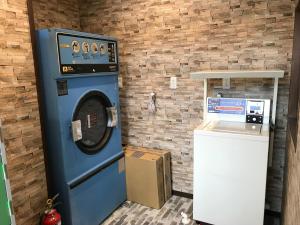 日光市にあるホテルファミテック 日光駅前の煉瓦の壁の横に青い洗濯機