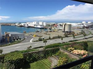 a view of a city with a road and a harbor at Terrace Apartment in Timaru