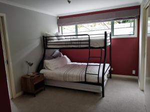 a bedroom with two bunk beds and a window at Central Taupo Townhouse in Taupo