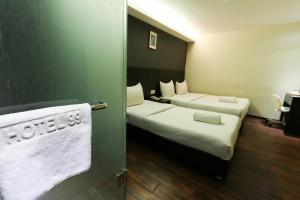 Voodi või voodid majutusasutuse Hotel 99 Bandar Klang (Meru) toas